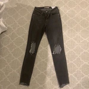 Size 25 vintage Levi washed out black jeans.